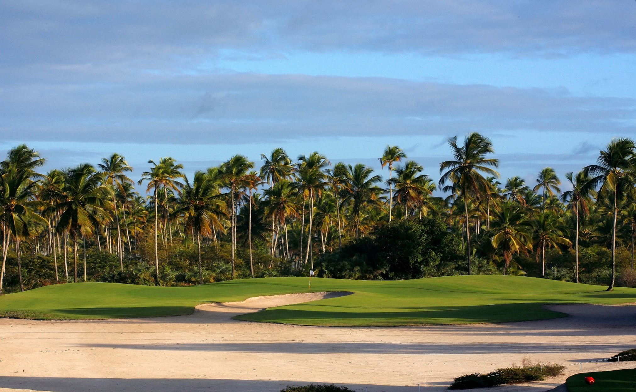 Hole #13 is a long par three at Comandatuba Ocean Course.  This challenging hole normally plays with the regions predominately northeast winds,   The native sand of Comandatuba Island makes this green a virtual island surrounded by sand.